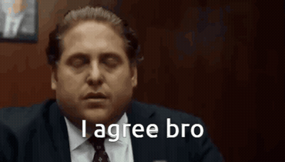A Man In A Suit And Tie Is Saying `` I Agree Bro '' While Sitting In A Chair . GIF