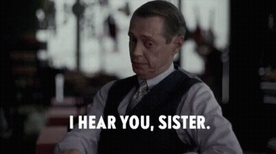 A Man In A Suit And Tie Is Saying I Hear You Sister . GIF
