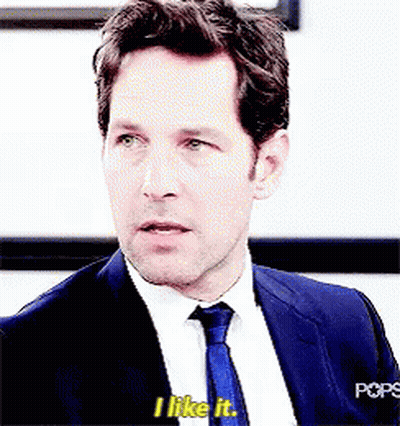 A Man In A Suit And Tie Is Saying I Like It . GIF