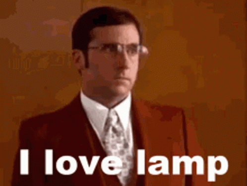 A Man In A Suit And Tie Is Saying I Love Lamp . GIF