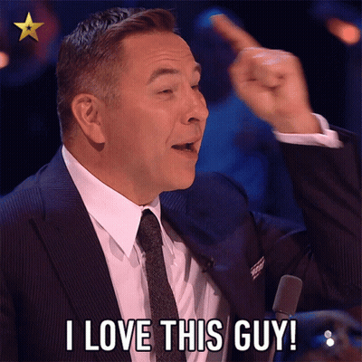 A Man In A Suit And Tie Is Saying " I Love This Guy " GIF