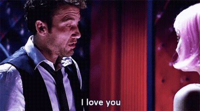 A Man In A Suit And Tie Is Saying I Love You GIF