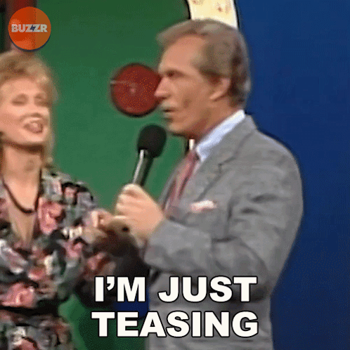 A Man In A Suit And Tie Is Saying I 'M Just Teasing GIF