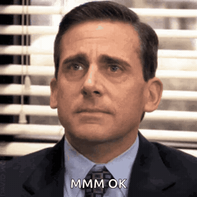 A Man In A Suit And Tie Is Saying Mmm Ok . GIF