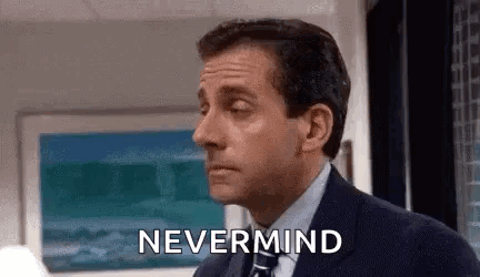 A Man In A Suit And Tie Is Saying `` Nevermind '' In Front Of A Painting . GIF