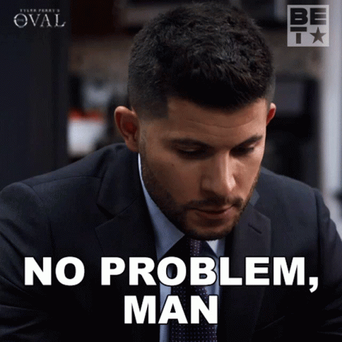 A Man In A Suit And Tie Is Saying No Problem Man GIF