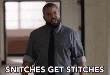 A Man In A Suit And Tie Is Saying Snitches Get Stitches . GIF