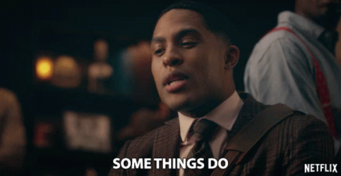 A Man In A Suit And Tie Is Saying Somethings Do GIF