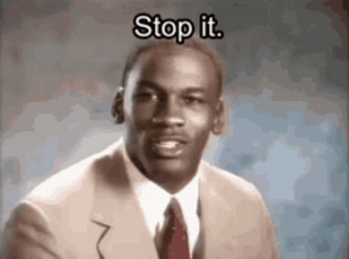A Man In A Suit And Tie Is Saying Stop It . GIF
