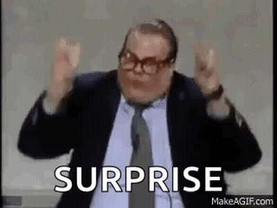 A Man In A Suit And Tie Is Saying Surprise . GIF