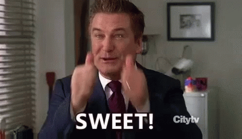 A Man In A Suit And Tie Is Saying Sweet With His Hands In The Air . GIF