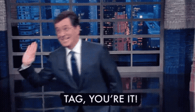 A Man In A Suit And Tie Is Saying Tag , You 'Re It GIF