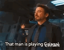 A Man In A Suit And Tie Is Saying That Man Is Playing Captain GIF