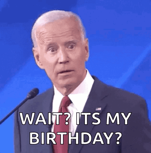 A Man In A Suit And Tie Is Saying Wait ? It 'S My Birthday GIF