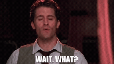 A Man In A Suit And Tie Is Saying Wait What . GIF