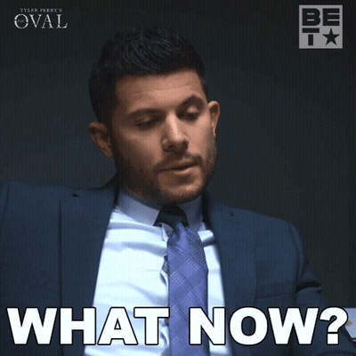 A Man In A Suit And Tie Is Saying What Now GIF