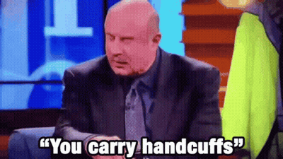 A Man In A Suit And Tie Is Saying " You Carry Handcuffs " . GIF