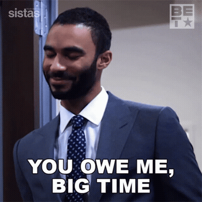 A Man In A Suit And Tie Is Saying You Owe Me Big Time GIF