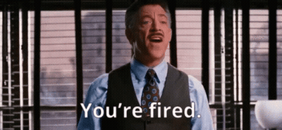 A Man In A Suit And Tie Is Saying `` You 'Re Fired '' In Front Of A Window . GIF