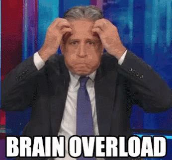 A Man In A Suit And Tie Is Scratching His Head With The Words Brain Overload Above Him GIF