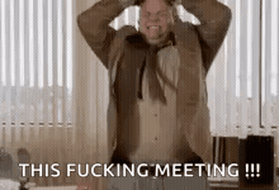 A Man In A Suit And Tie Is Screaming And Holding His Head In A Room . GIF