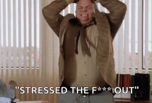 A Man In A Suit And Tie Is Screaming And Holding His Head While Saying `` Stressed The F ** Out '' . GIF