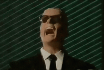 A Man In A Suit And Tie Is Screaming In Front Of A Green Striped Wall . GIF