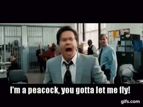 A Man In A Suit And Tie Is Screaming While Standing In A Room . GIF