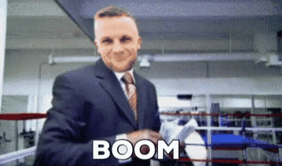 A Man In A Suit And Tie Is Shaking Hands In A Boxing Ring And The Word Boom Is On The Bottom GIF