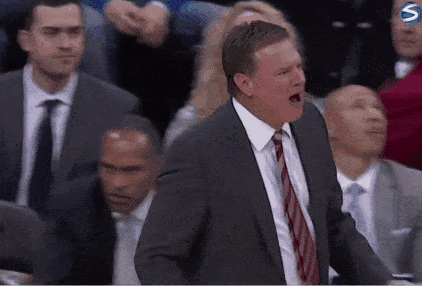 A Man In A Suit And Tie Is Shouting At A Basketball Game GIF
