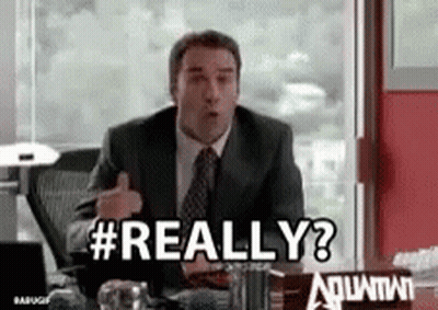 A Man In A Suit And Tie Is Sitting At A Desk And Saying Really ? GIF