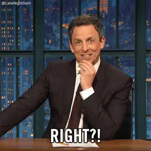 A Man In A Suit And Tie Is Sitting At A Desk And Says Right GIF