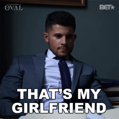 A Man In A Suit And Tie Is Sitting At A Desk And Says That 'S My Girlfriend GIF