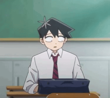 A Man In A Suit And Tie Is Sitting At A Desk In A Classroom With A Tablet . GIF