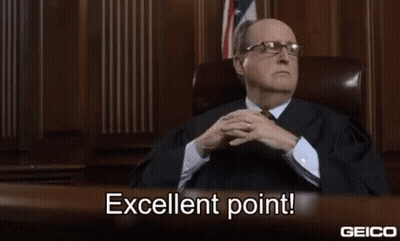 A Man In A Suit And Tie Is Sitting At A Desk In A Courtroom And Says Excellent Point . GIF