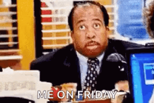 A Man In A Suit And Tie Is Sitting At A Desk In Front Of A Laptop Computer And Says `` Me On Friday '' . GIF