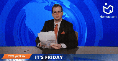 A Man In A Suit And Tie Is Sitting At A Desk In Front Of A Screen That Says " It 'S Friday " GIF