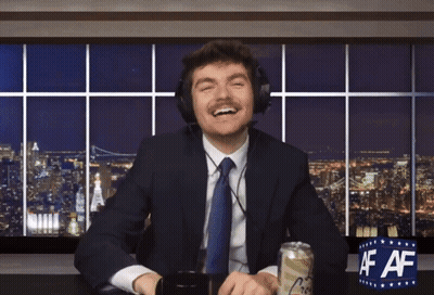 A Man In A Suit And Tie Is Sitting At A Desk With A Can Of Beer And A Sign That Says Af Af GIF