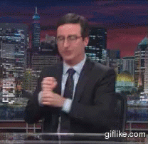A Man In A Suit And Tie Is Sitting At A Desk With A Giflike.com Logo On The Bottom GIF