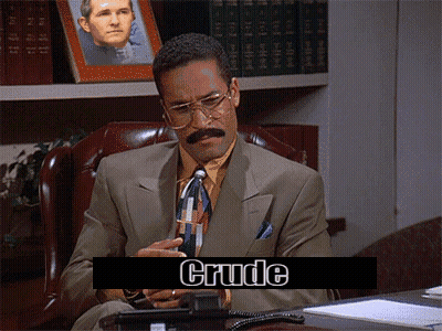 A Man In A Suit And Tie Is Sitting At A Desk With Crude Written On The Screen Behind Him GIF