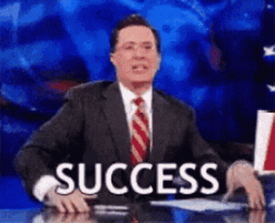 A Man In A Suit And Tie Is Sitting At A Desk With The Word Success In Front Of Him . GIF
