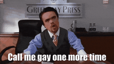 A Man In A Suit And Tie Is Sitting At A Desk With The Words Call Me Gay One More Time GIF
