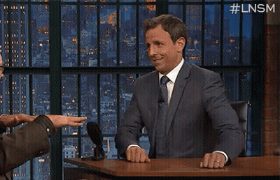 A Man In A Suit And Tie Is Sitting At A Desk With The Words Knock On Written On It GIF