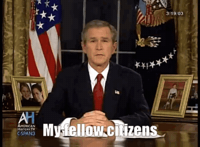 A Man In A Suit And Tie Is Sitting At A Desk With The Words My Fellow Citizens Written In Front Of Him GIF