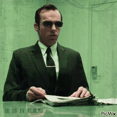 A Man In A Suit And Tie Is Sitting At A Desk With The Words " Or Is It Real " On The Bottom GIF
