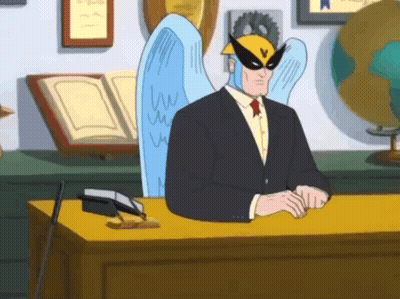 A Man In A Suit And Tie Is Sitting At A Desk GIF