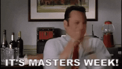 A Man In A Suit And Tie Is Sitting At A Table And Says It 'S Masters Week . GIF