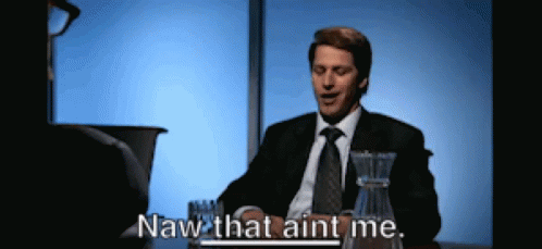 A Man In A Suit And Tie Is Sitting At A Table And Says Naw That Aint Me GIF