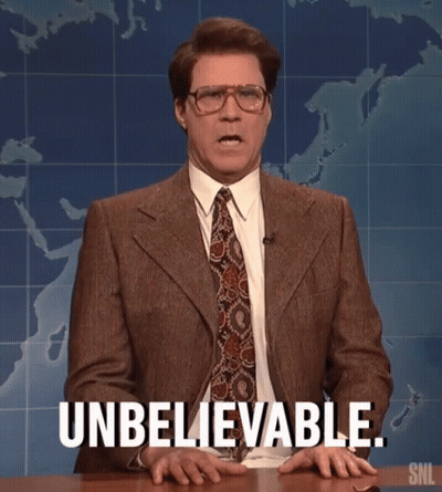 A Man In A Suit And Tie Is Sitting At A Table And Says Unbelievable . GIF