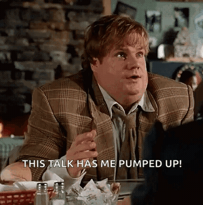 A Man In A Suit And Tie Is Sitting At A Table In A Restaurant And Talking To Someone . GIF